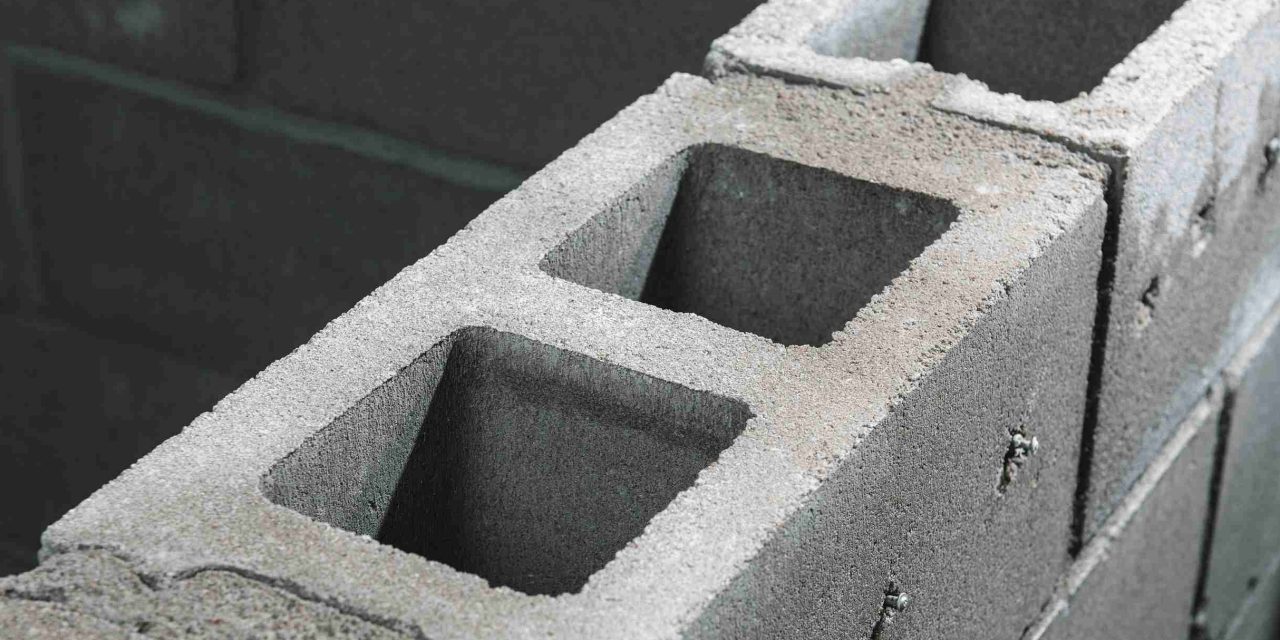 Worker breaks through a concrete wall more easily with help from the EXO T-22 Tool balancer